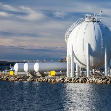 Spherical gas holder stands on sea coast